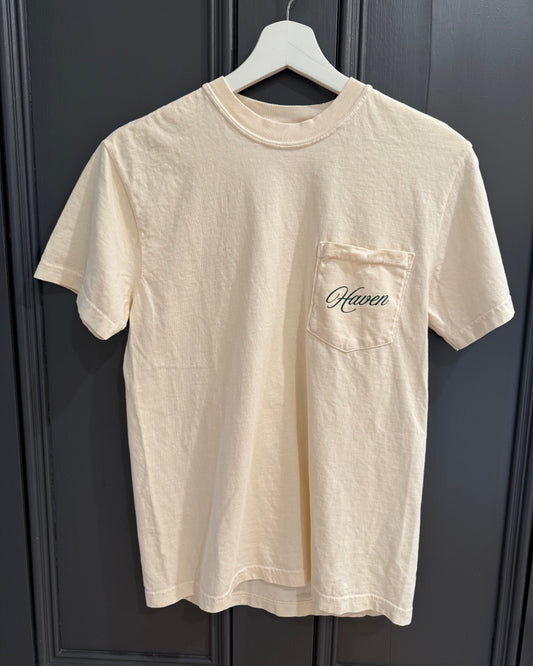 Ivory t-shirt with 'Haven' logo on a dark background